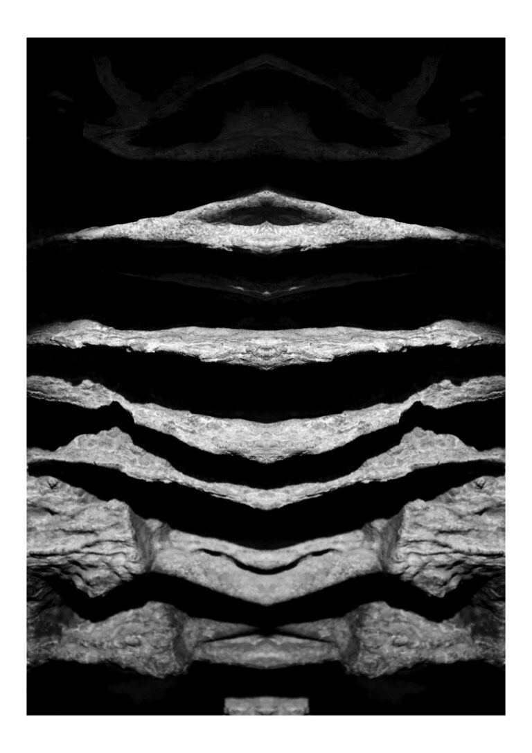 Yakamoza - Black and white photography of dripping cave stone formation put in vertical symmetry